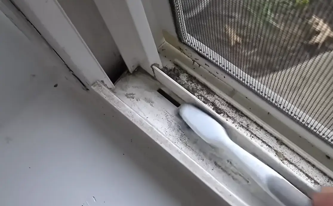 Awbrey Butte window cleaning Brush scrubbing dirt and debris out of a sliding window track next to the screen